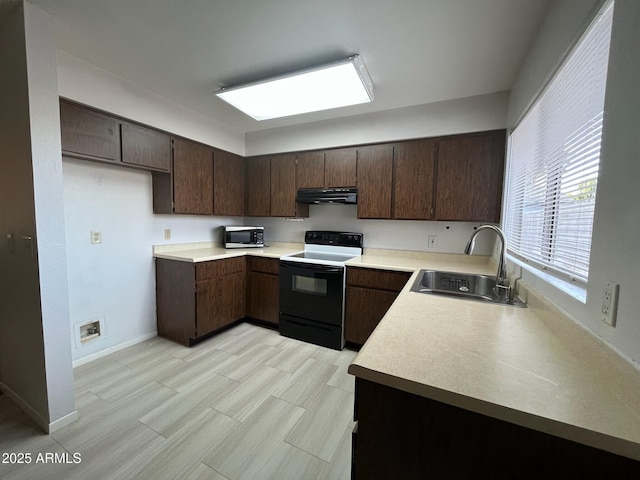 kitchen with under cabinet range hood, range with electric cooktop, a sink, light countertops, and stainless steel microwave