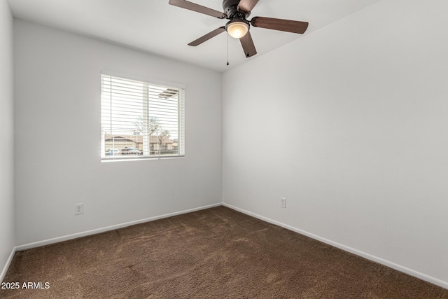 unfurnished room with dark carpet and ceiling fan