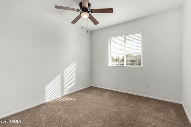 empty room featuring carpet floors and ceiling fan