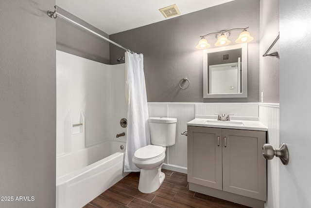 full bathroom featuring vanity, shower / bath combination with curtain, and toilet