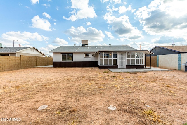 rear view of property featuring a patio and a sunroom