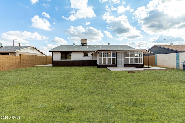 back of property featuring a sunroom, a lawn, and a patio area