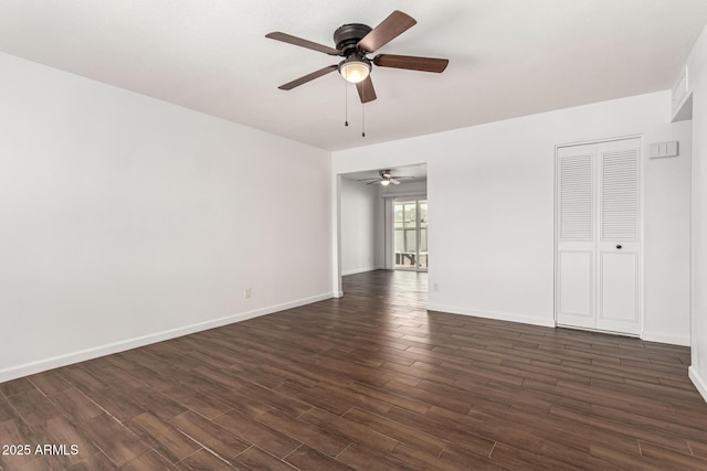 empty room with dark wood-type flooring and ceiling fan