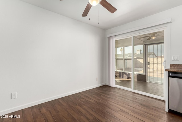 spare room featuring dark wood-type flooring and ceiling fan