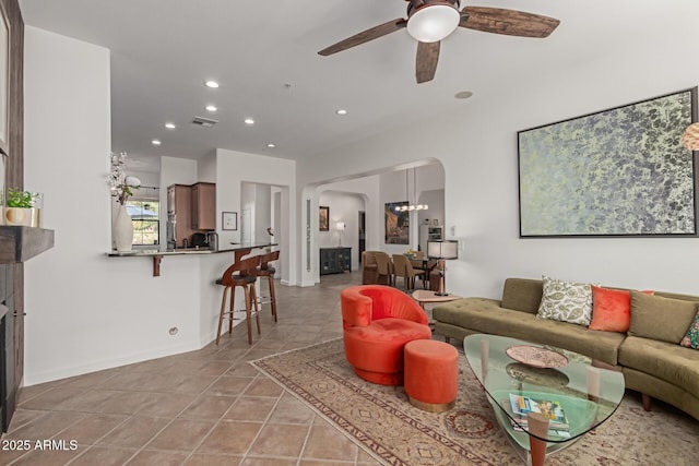 living room featuring light tile patterned floors and ceiling fan