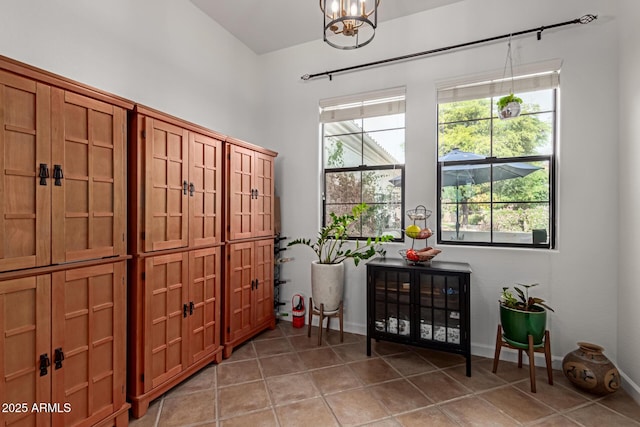 tiled foyer with an inviting chandelier