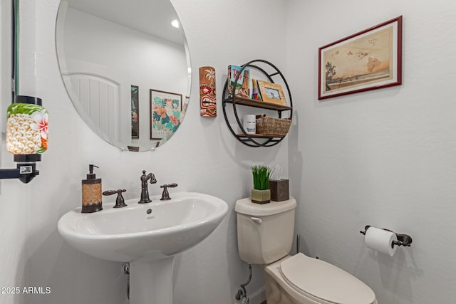 bathroom featuring toilet and sink