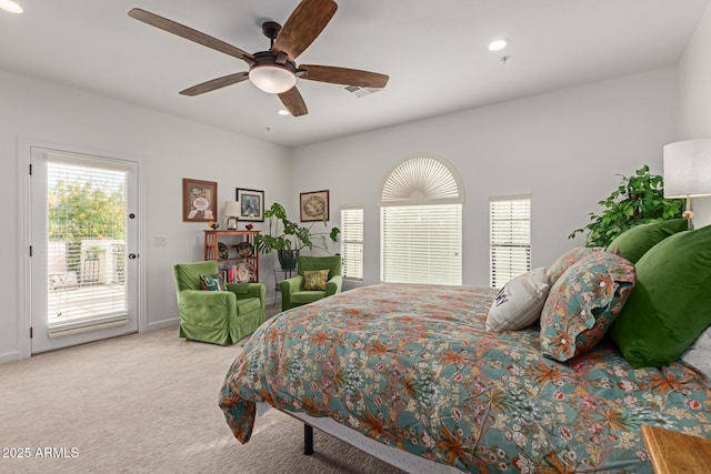 bedroom featuring access to outside, multiple windows, ceiling fan, and carpet