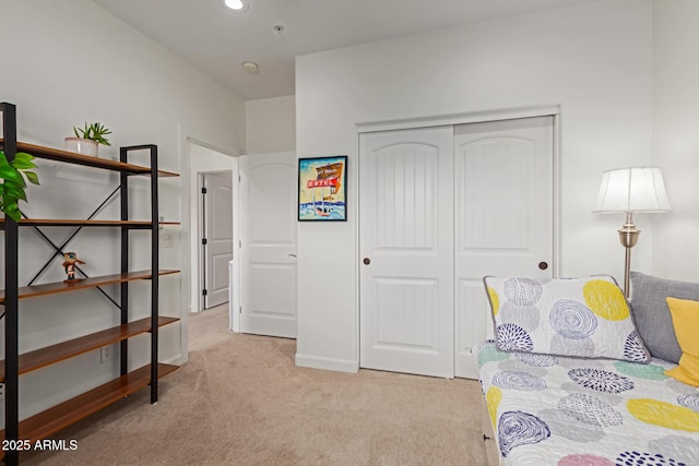 bedroom with a closet and light colored carpet