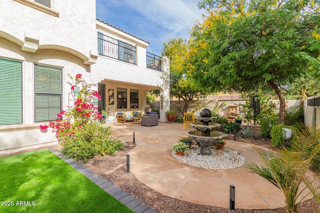 view of patio with an outdoor living space and a balcony