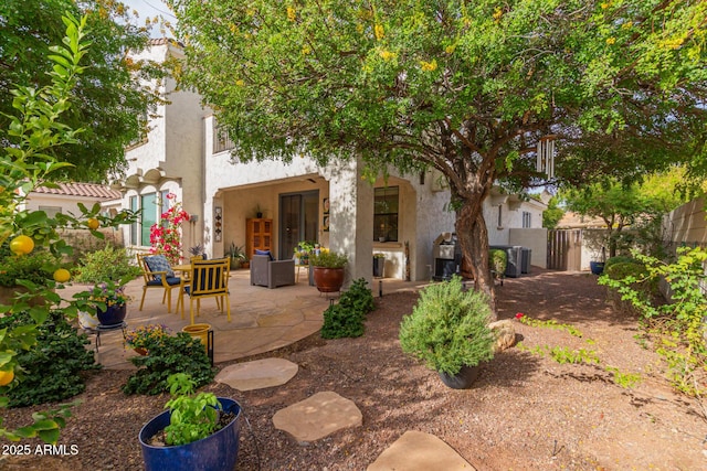 back of property with a patio