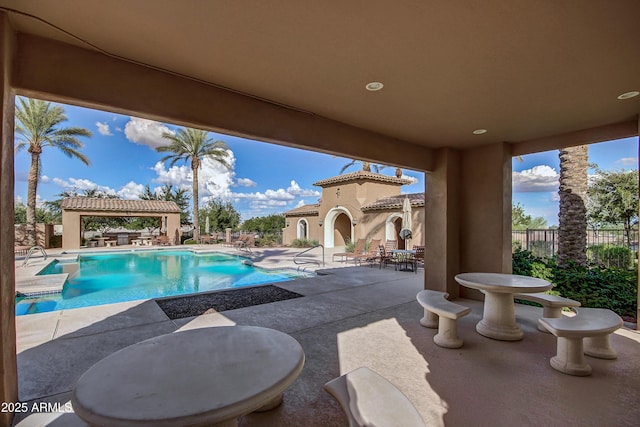 view of swimming pool featuring a patio area