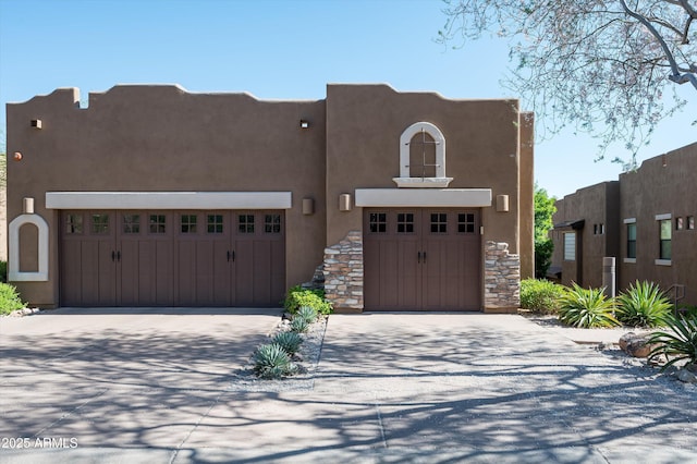 13300 E Via Linda Dr Unit 1058, Scottsdale, AZ 85259 - pueblo-style house with stucco siding, concrete driveway, and a garage