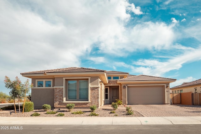 11019 E Tiburon Ave, Mesa, AZ 85212 - prairie-style house with a garage, driveway, stucco siding, and a tiled roof