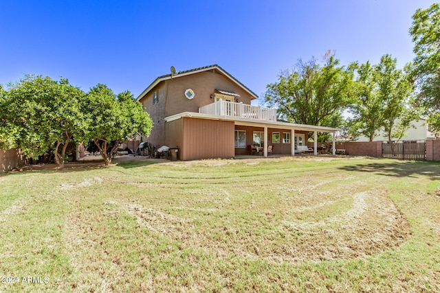 back of house featuring a yard and a patio area