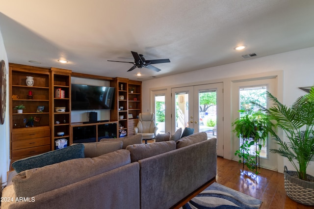 living room with ceiling fan, french doors, and dark hardwood / wood-style floors