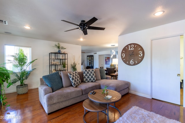 living room with ceiling fan and dark wood-type flooring