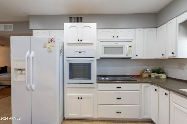 kitchen with white appliances, white cabinetry, and tasteful backsplash