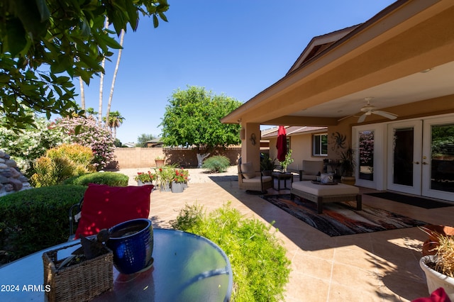 view of patio / terrace with outdoor lounge area, ceiling fan, and french doors