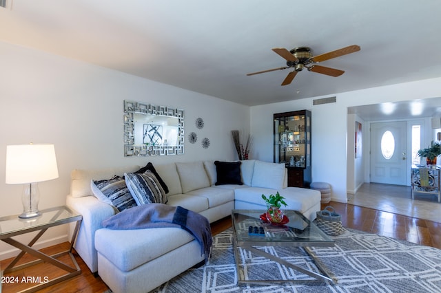 living room with hardwood / wood-style flooring and ceiling fan