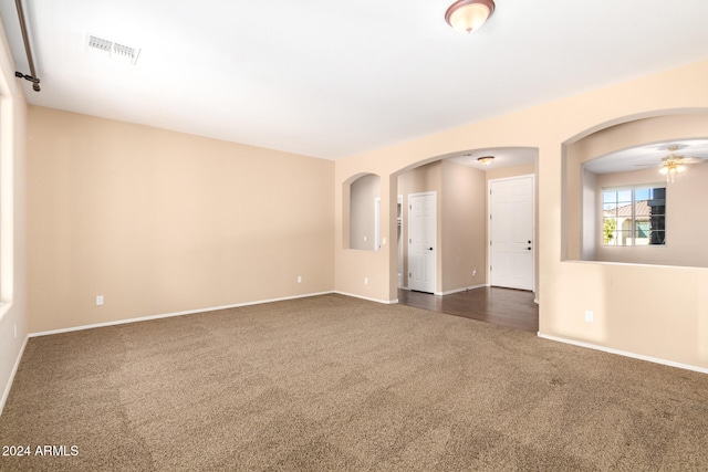 carpeted spare room with ceiling fan