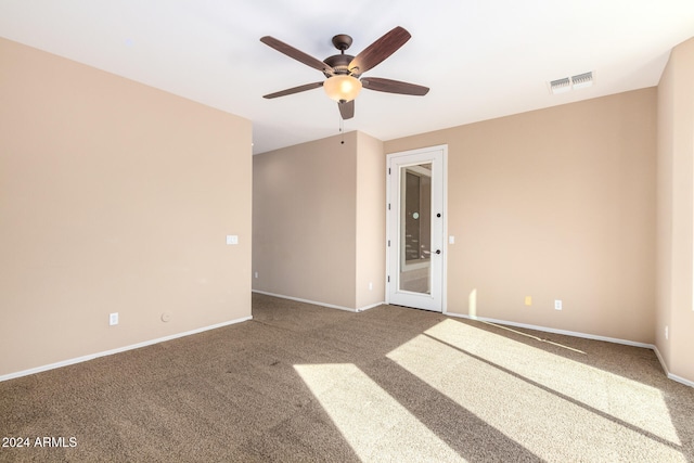 carpeted spare room with ceiling fan