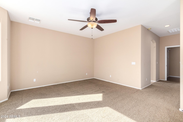 carpeted spare room with ceiling fan