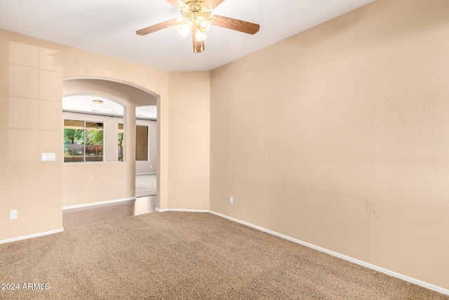 carpeted empty room with ceiling fan