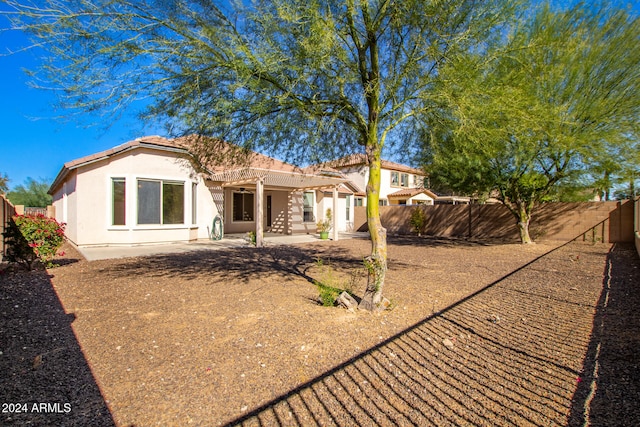 rear view of property with a pergola and a patio area