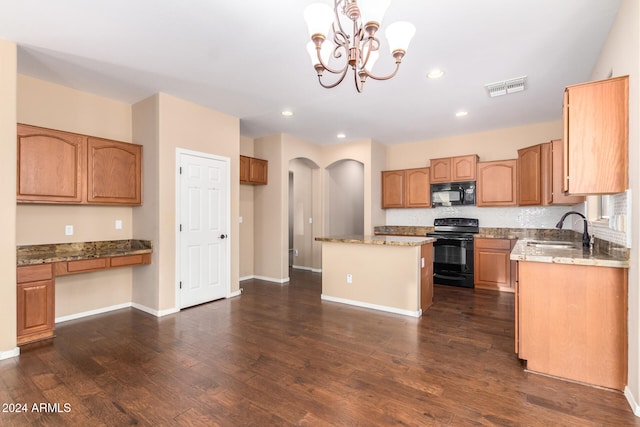 kitchen with sink, black appliances, dark hardwood / wood-style floors, a center island, and pendant lighting