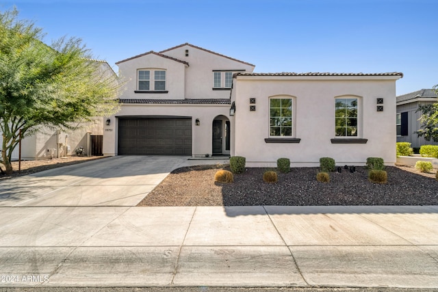 mediterranean / spanish home with a garage