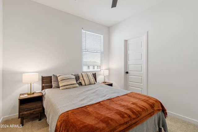 bedroom featuring light colored carpet and ceiling fan