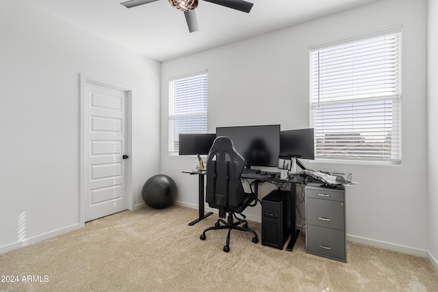 carpeted office space with ceiling fan