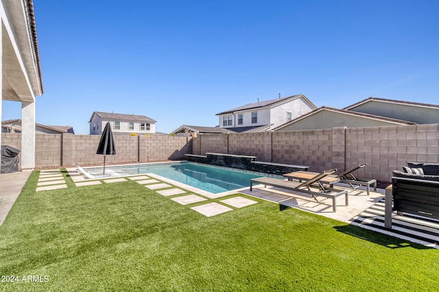 view of swimming pool with a yard and a patio area