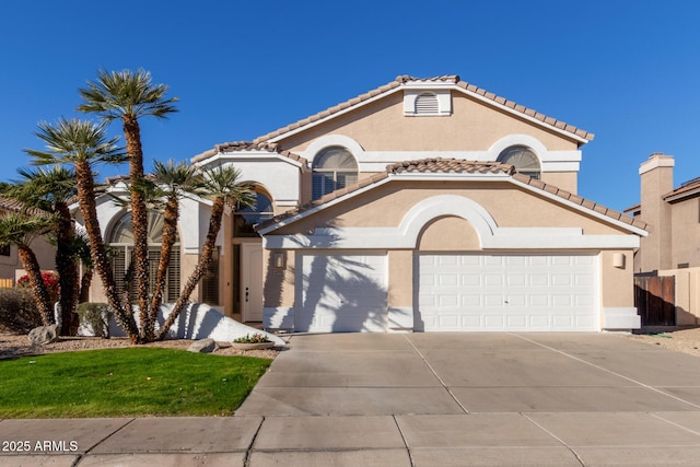 mediterranean / spanish house with a garage