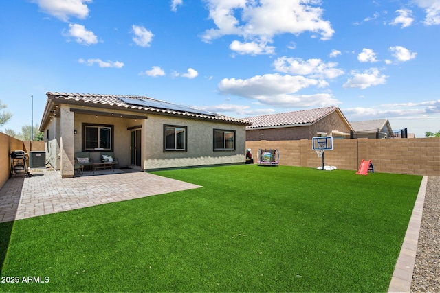 2753 E Fossil Ridge Rd, Phoenix, AZ 85050 - rear view of property with stucco siding, roof mounted solar panels, a fenced backyard, and a tiled roof
