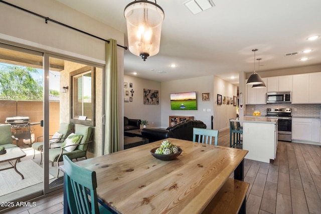 2753 E Fossil Ridge Rd, Phoenix, AZ 85050 - dining area with wood finished floors and recessed lighting