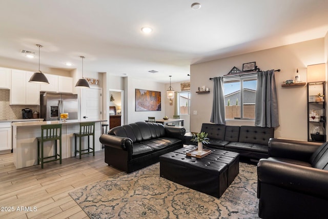 2753 E Fossil Ridge Rd, Phoenix, AZ 85050 - living room with light wood finished floors and recessed lighting