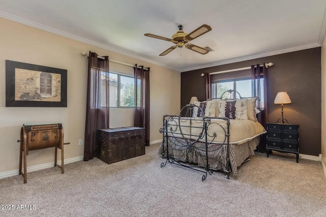 carpeted bedroom featuring a ceiling fan, crown molding, and baseboards