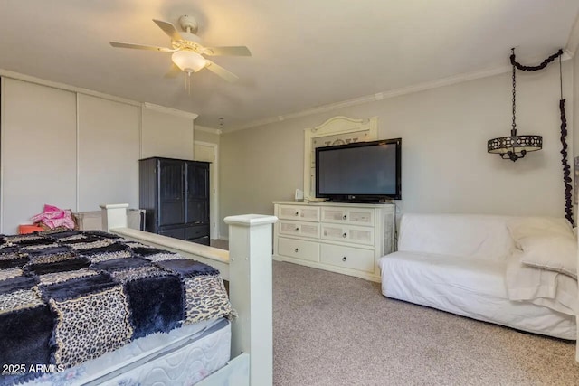 carpeted bedroom with ceiling fan and ornamental molding