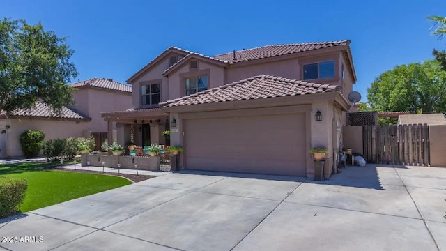 mediterranean / spanish house with stucco siding, driveway, a garage, and fence