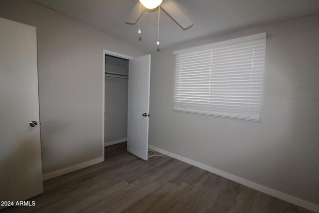 unfurnished bedroom featuring a closet, ceiling fan, and dark hardwood / wood-style flooring