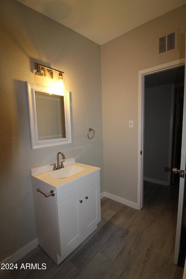 bathroom with vanity and hardwood / wood-style floors