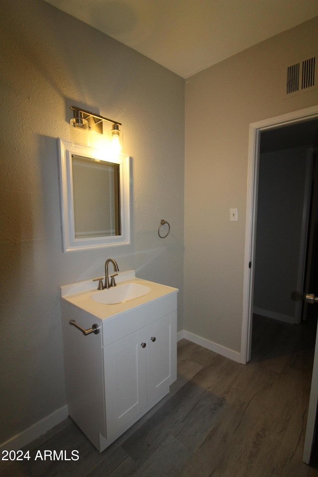 bathroom with vanity and hardwood / wood-style floors