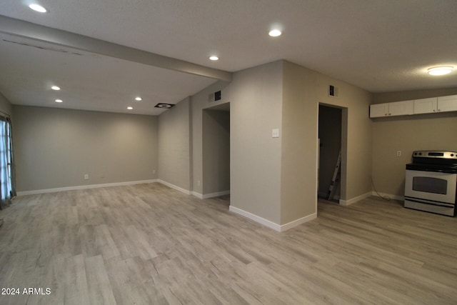 interior space with a textured ceiling and light wood-type flooring