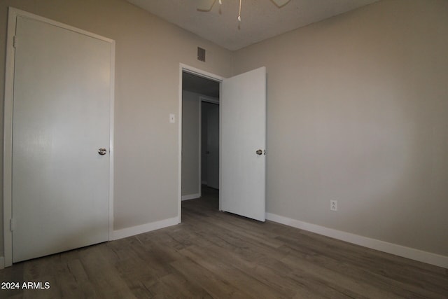 unfurnished bedroom with hardwood / wood-style floors and ceiling fan