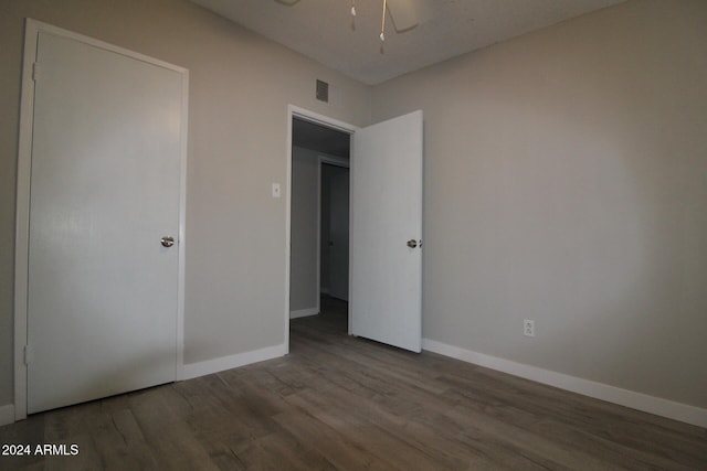 unfurnished bedroom featuring hardwood / wood-style flooring and ceiling fan