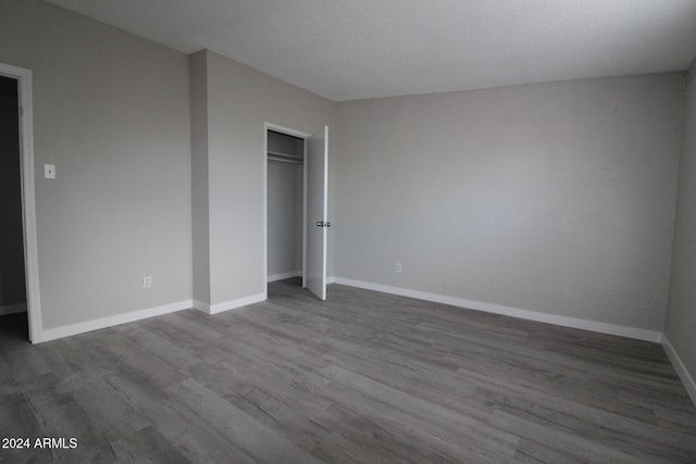 unfurnished bedroom featuring hardwood / wood-style flooring