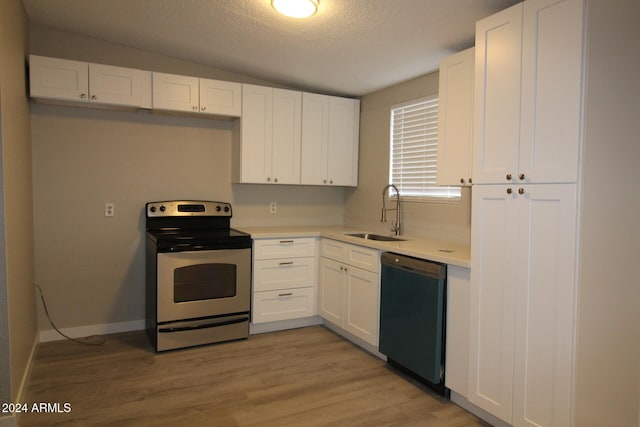 kitchen featuring black dishwasher, sink, light wood-type flooring, electric range, and white cabinetry