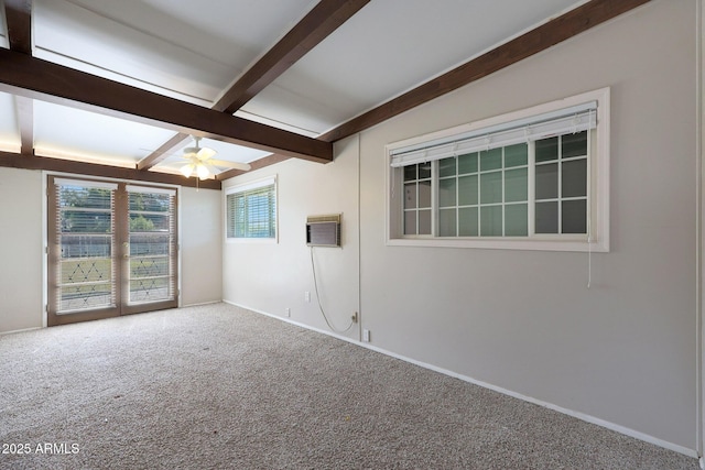 carpeted spare room with ceiling fan, a wall mounted AC, and beamed ceiling